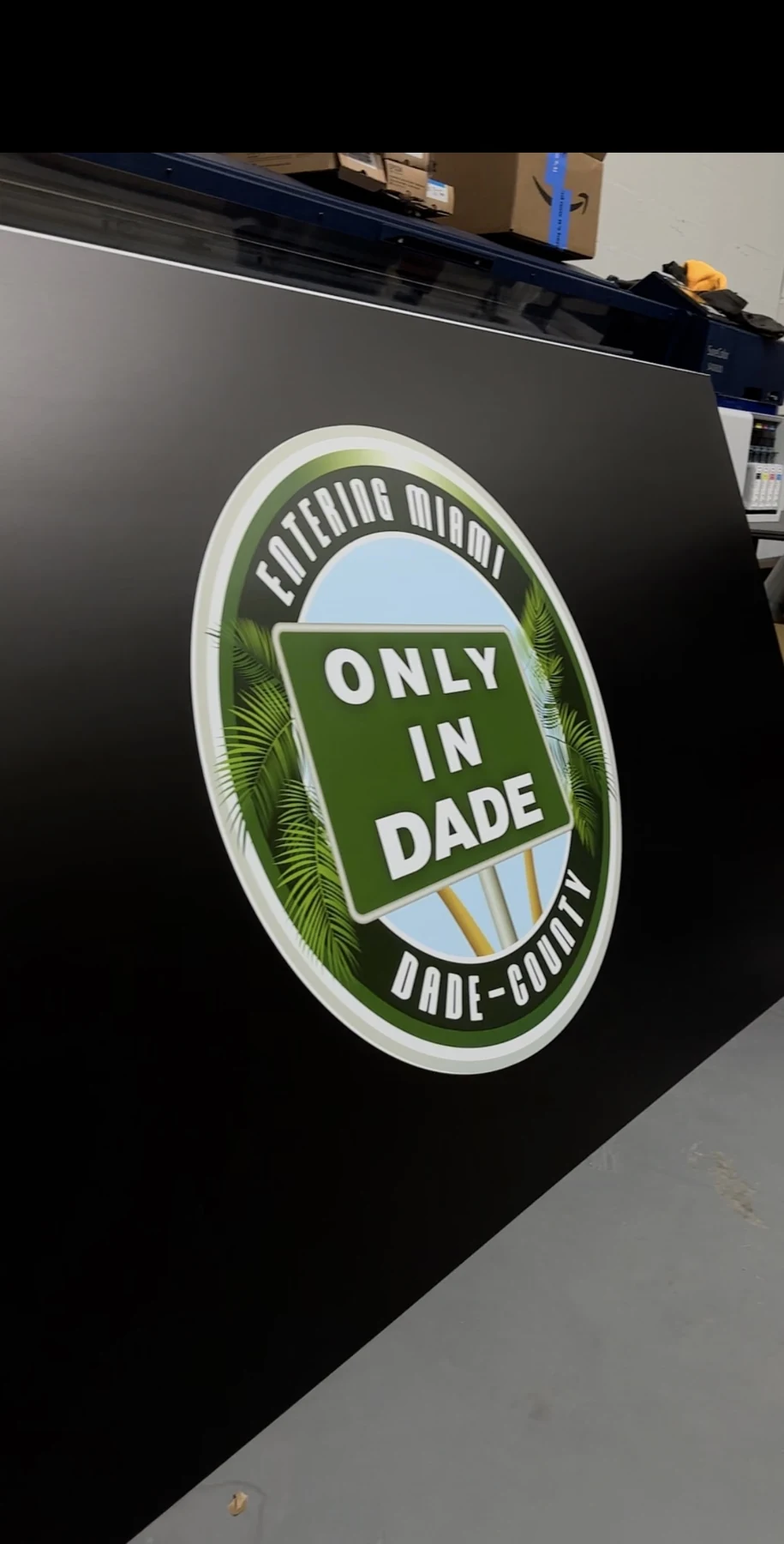 A circular event logo applied to a black DJ booth