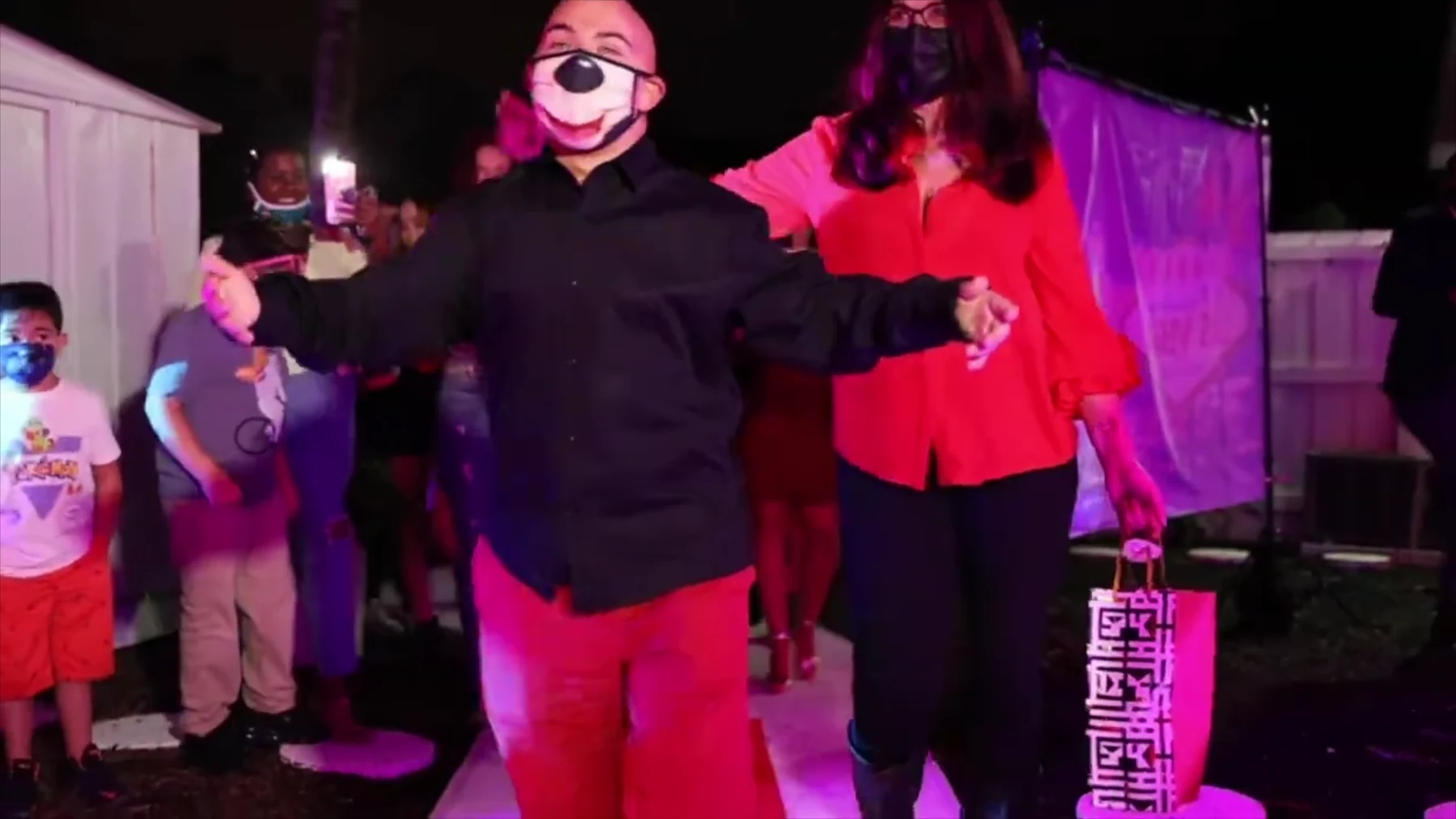 Costumed Hora Loca performers joining guests at an event