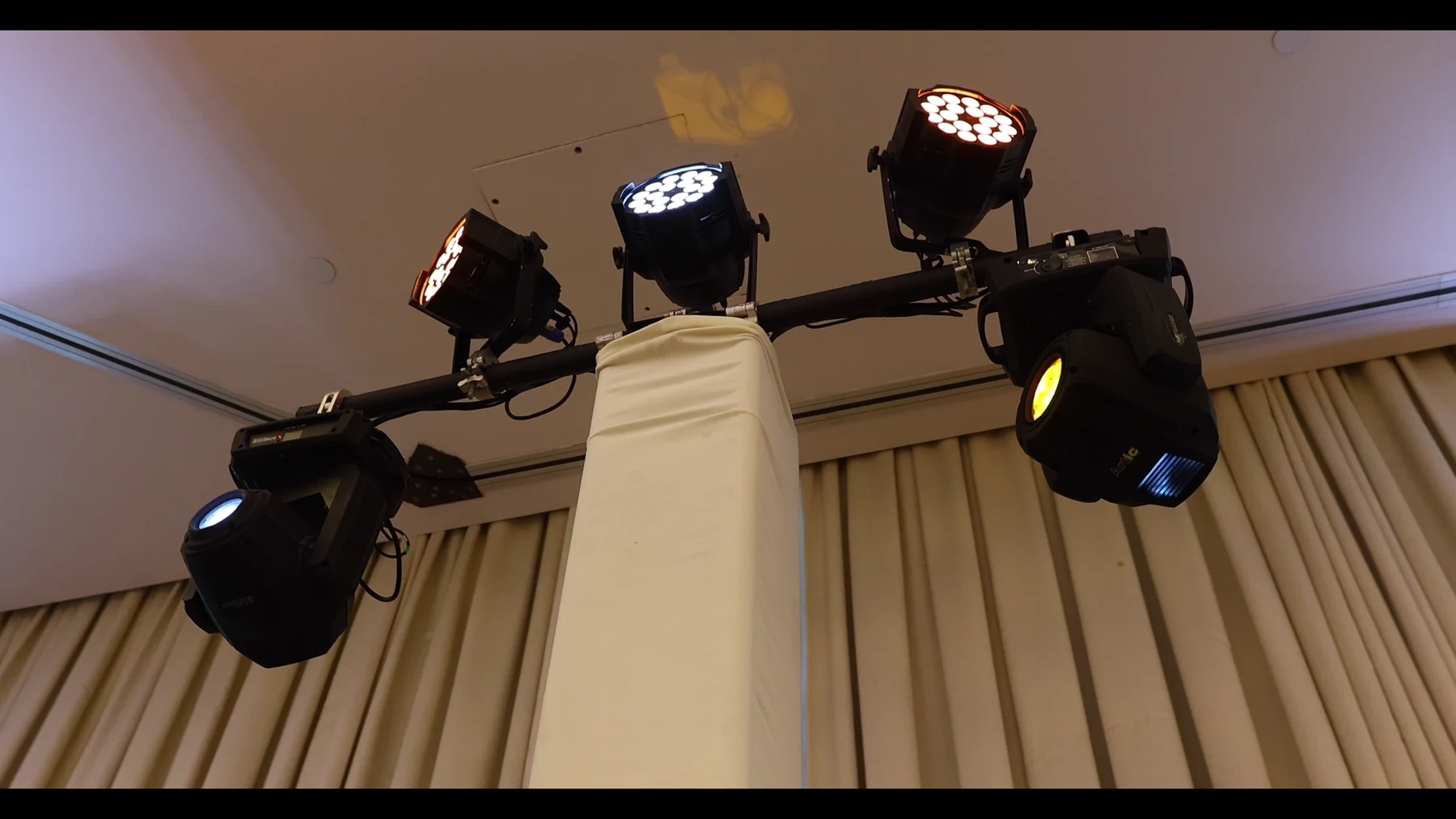 Event lighting fixtures mounted above the DJ setup