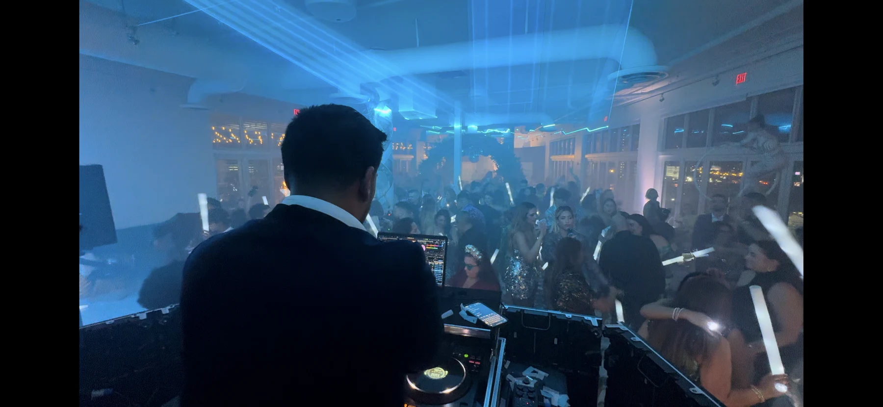A DJ looking across a wedding dance floor