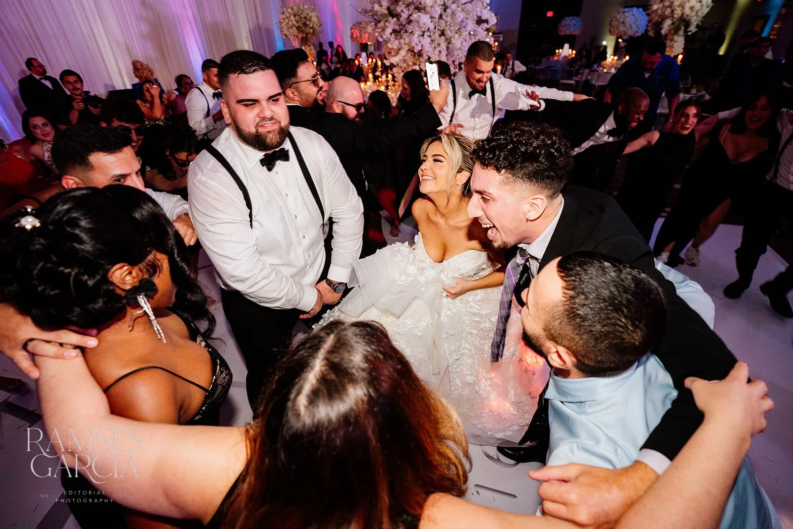 A wedding celebration on a crowded dance floor